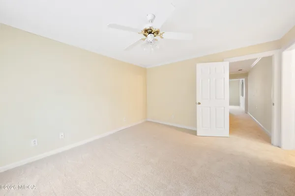 a view of a room with a ceiling fan and a window