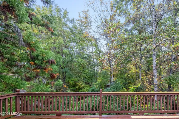 a view of a wooden fence and trees