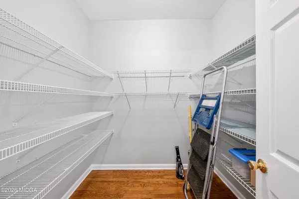a view of walk in closet with empty racks
