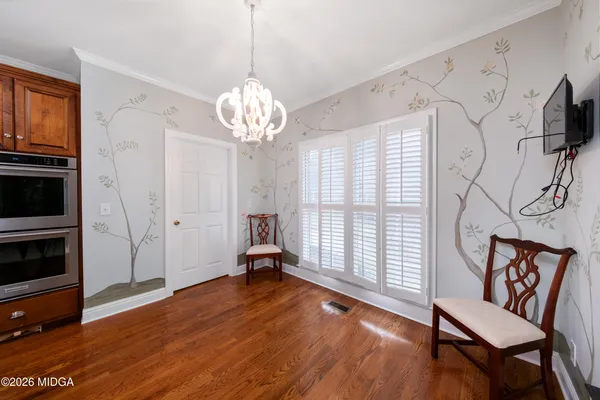 a view of a livingroom with wooden floor and a window