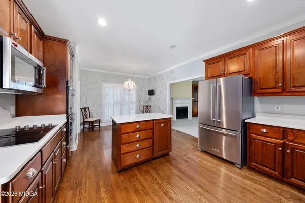 a kitchen with stainless steel appliances a refrigerator and wooden cabinets