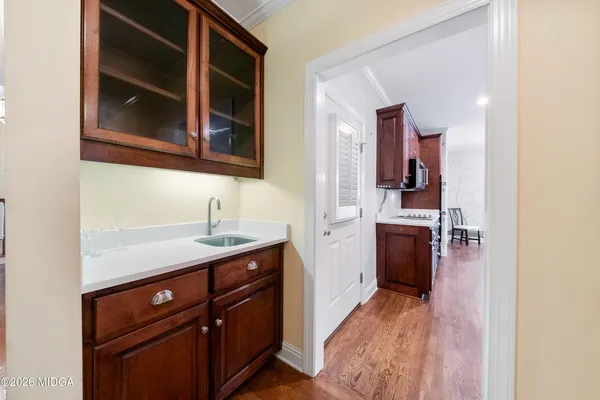 a kitchen with a sink cabinets and wooden floor