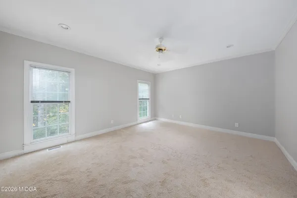 an empty room with a empty space and windows