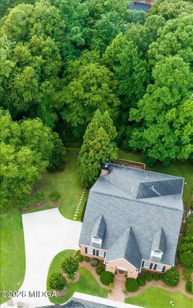 a aerial view of a house with a yard and lake view