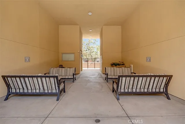 a view of a patio with table and chairs under an umbrella