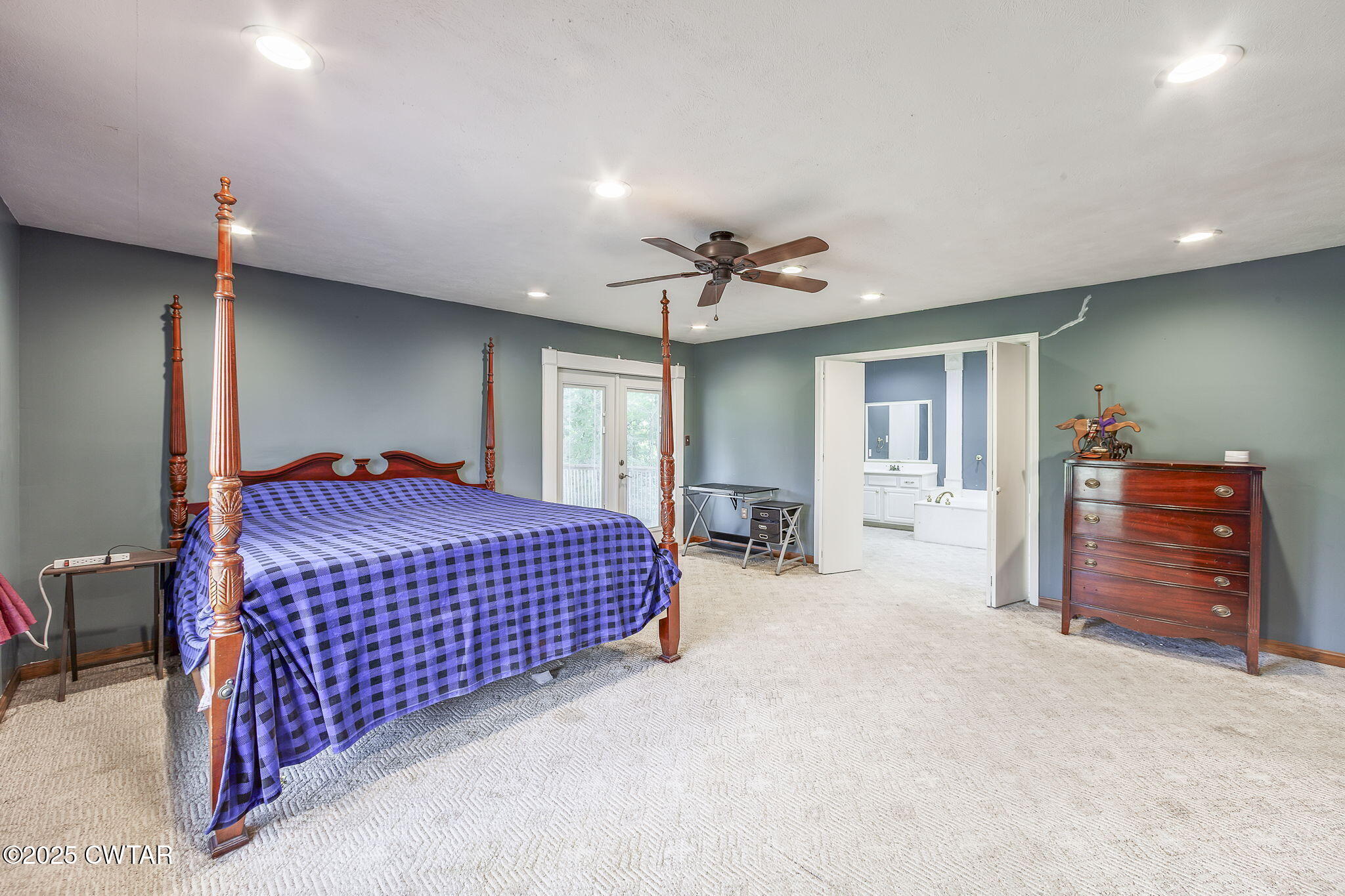499 Diamond Grove Road Beech Bluff, TN 38313 - Photo 12 of 28 a spacious bedroom with a bed and a chandelier