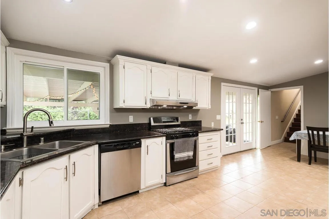 9399 Weber Court Spring Valley, CA 91977 - Photo 11 of 41 a kitchen with stainless steel appliances granite countertop a stove a sink and a microwave