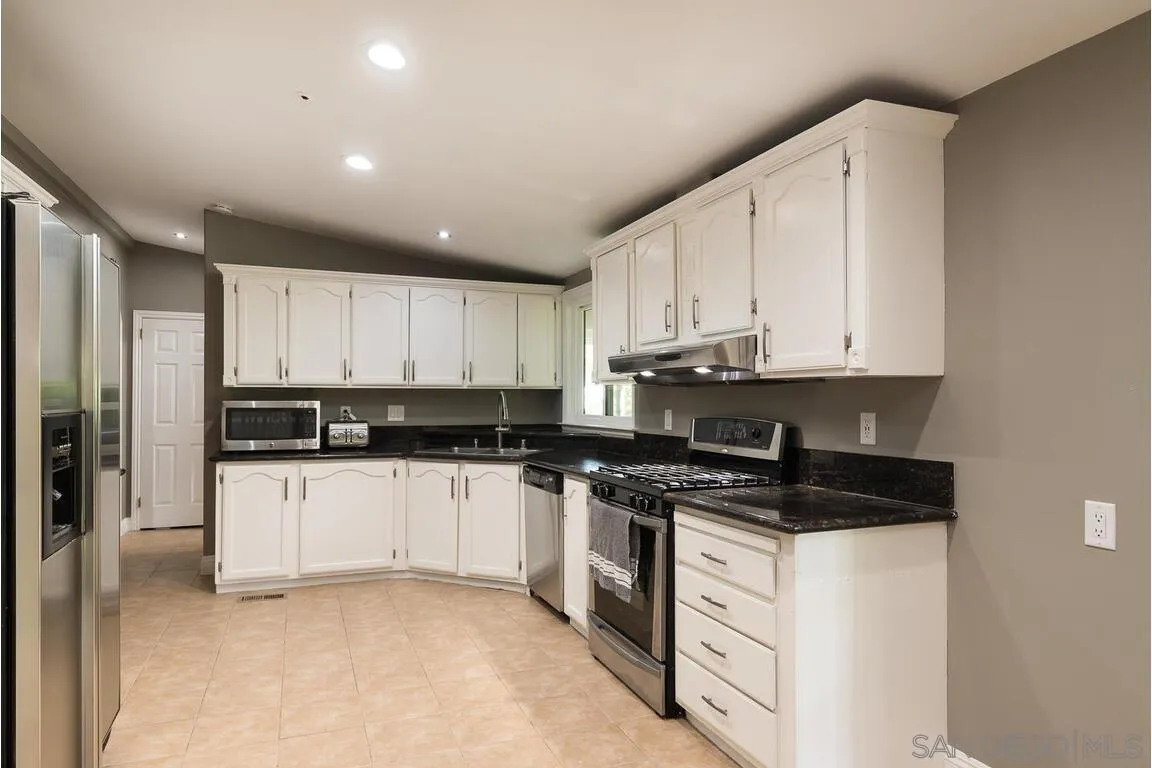 9399 Weber Court Spring Valley, CA 91977 - Photo 12 of 41 a kitchen with stainless steel appliances granite countertop a stove a sink and a refrigerator