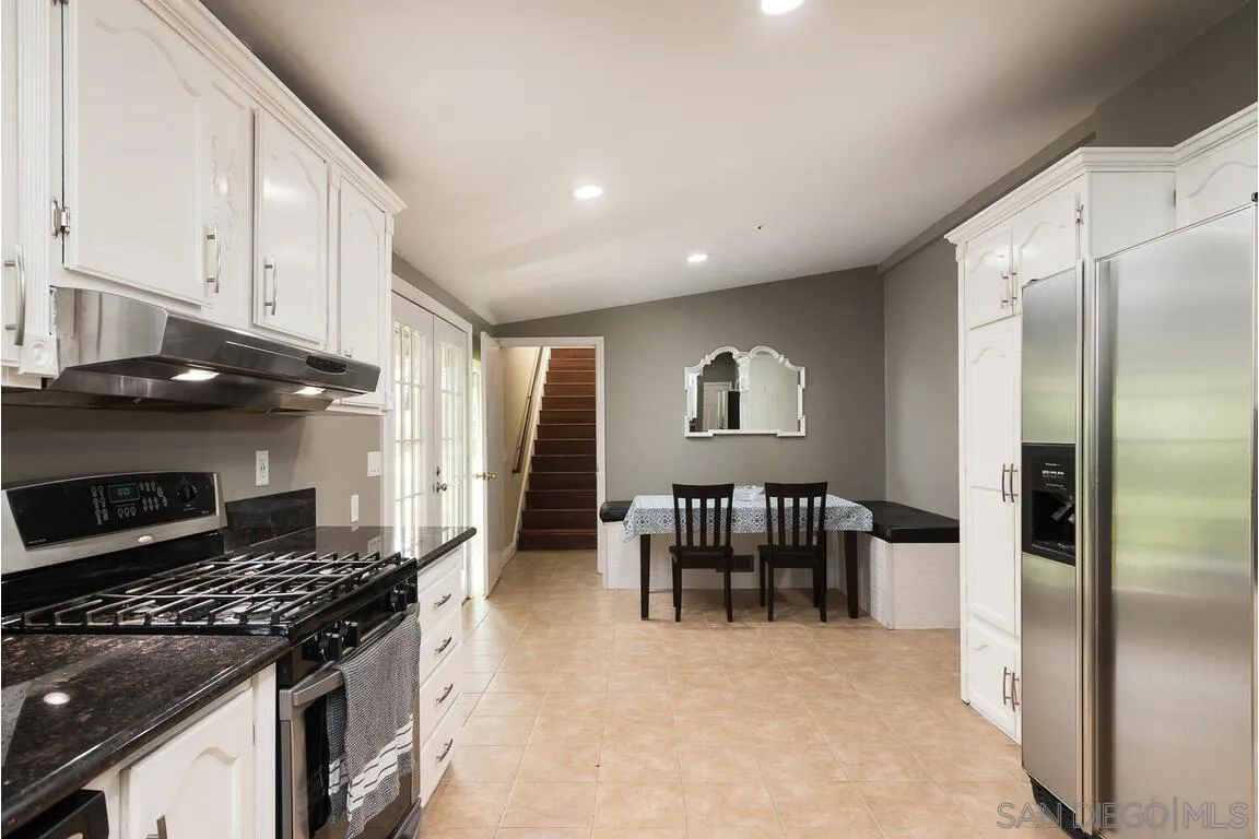 9399 Weber Court Spring Valley, CA 91977 - Photo 13 of 41 a kitchen with stainless steel appliances granite countertop a stove and a refrigerator