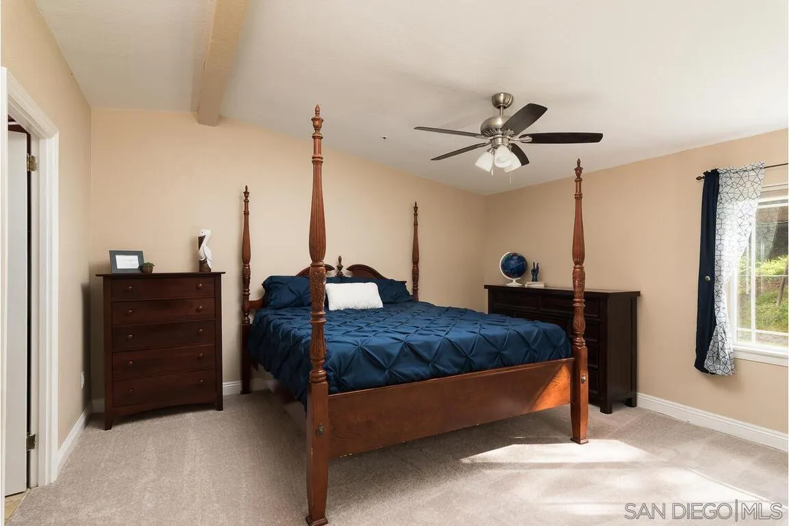 9399 Weber Court Spring Valley, CA 91977 - Photo 19 of 41 a bed room with a bed and a chandelier