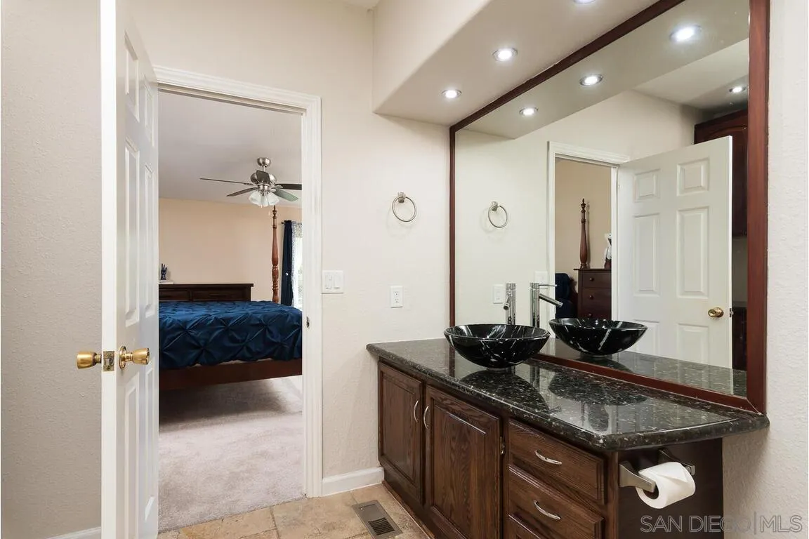 9399 Weber Court Spring Valley, CA 91977 - Photo 22 of 41 a kitchen with a sink and cabinets