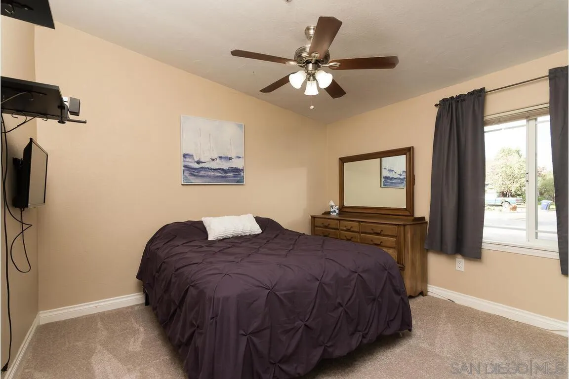 9399 Weber Court Spring Valley, CA 91977 - Photo 25 of 41 a bedroom with a large bed and a window