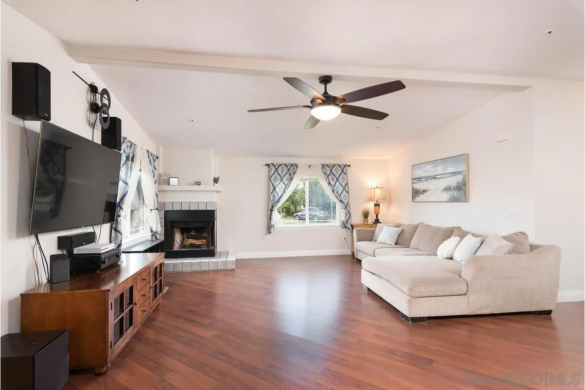 9399 Weber Court Spring Valley, CA 91977 - Photo 3 of 41 a living room with furniture fireplace and flat screen tv