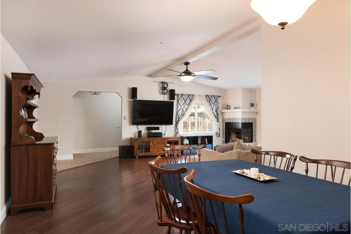 9399 Weber Court Spring Valley, CA 91977 - Photo 8 of 41 a living room with furniture a flat screen tv and kitchen view