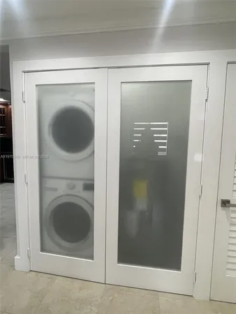 a view of a hallway with washer and dryer