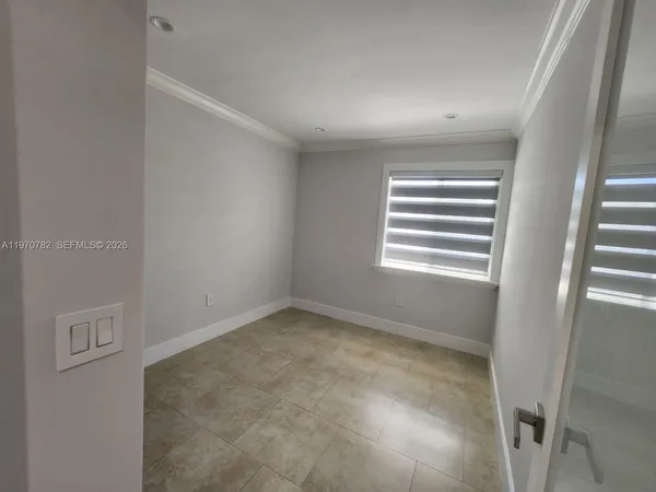 a view of empty room with windows