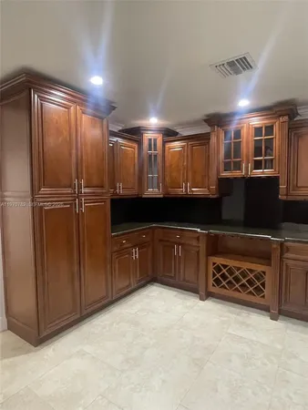 a kitchen with a refrigerator and a sink
