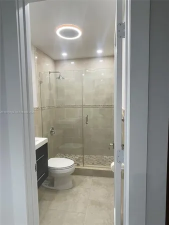 a bathroom with a toilet and a shower