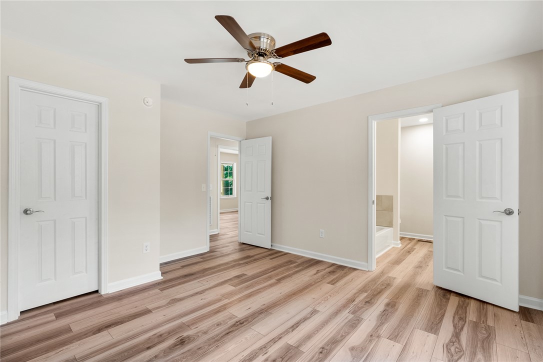 131 Lockaby Road Pelzer, SC 29669 - Photo 25 of 50 This bright room features a ceiling fan, durable flooring, and direct access to an adjacent bathroom.