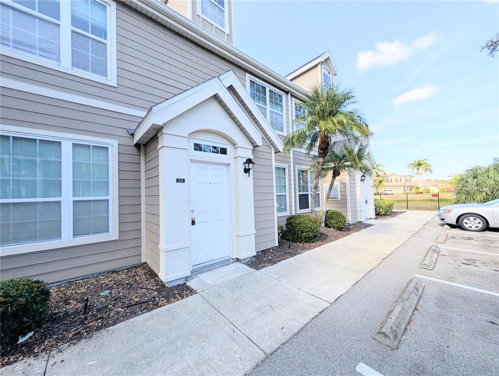 5531 Rosehill Road, Unit 203 Sarasota, FL 34233 - Photo 1 of 18 a front view of a house with garden