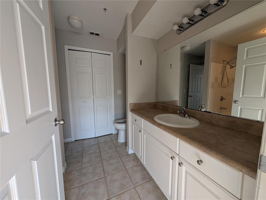 5531 Rosehill Road, Unit 203 Sarasota, FL 34233 - Photo 13 of 18 a bathroom with a granite countertop sink and a mirror