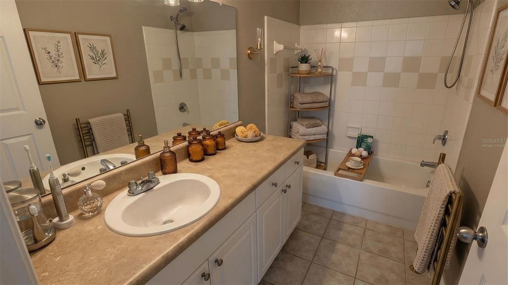 5531 Rosehill Road, Unit 203 Sarasota, FL 34233 - Photo 16 of 18 a bathroom with a tub sink and mirror