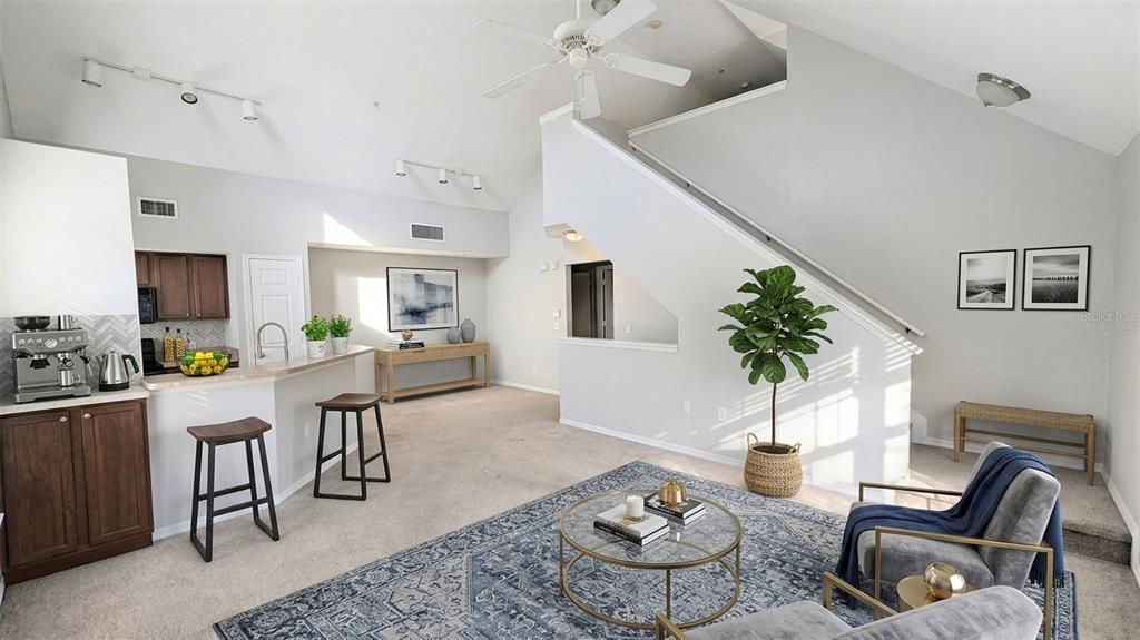 5531 Rosehill Road, Unit 203 Sarasota, FL 34233 - Photo 3 of 18 a living room with furniture potted plant and open kitchen view