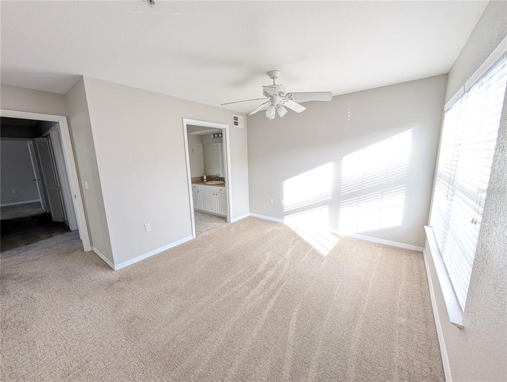 5531 Rosehill Road, Unit 203 Sarasota, FL 34233 - Photo 9 of 18 a view of empty room with wooden floor and fan