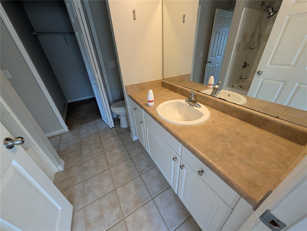 5531 Rosehill Road, Unit 203 Sarasota, FL 34233 - Photo 10 of 18 a bathroom with a double vanity sink and mirror