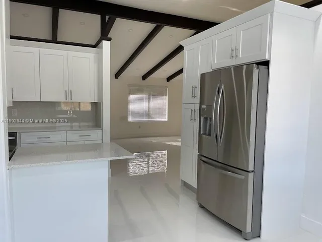 a kitchen with stainless steel appliances a refrigerator and a sink