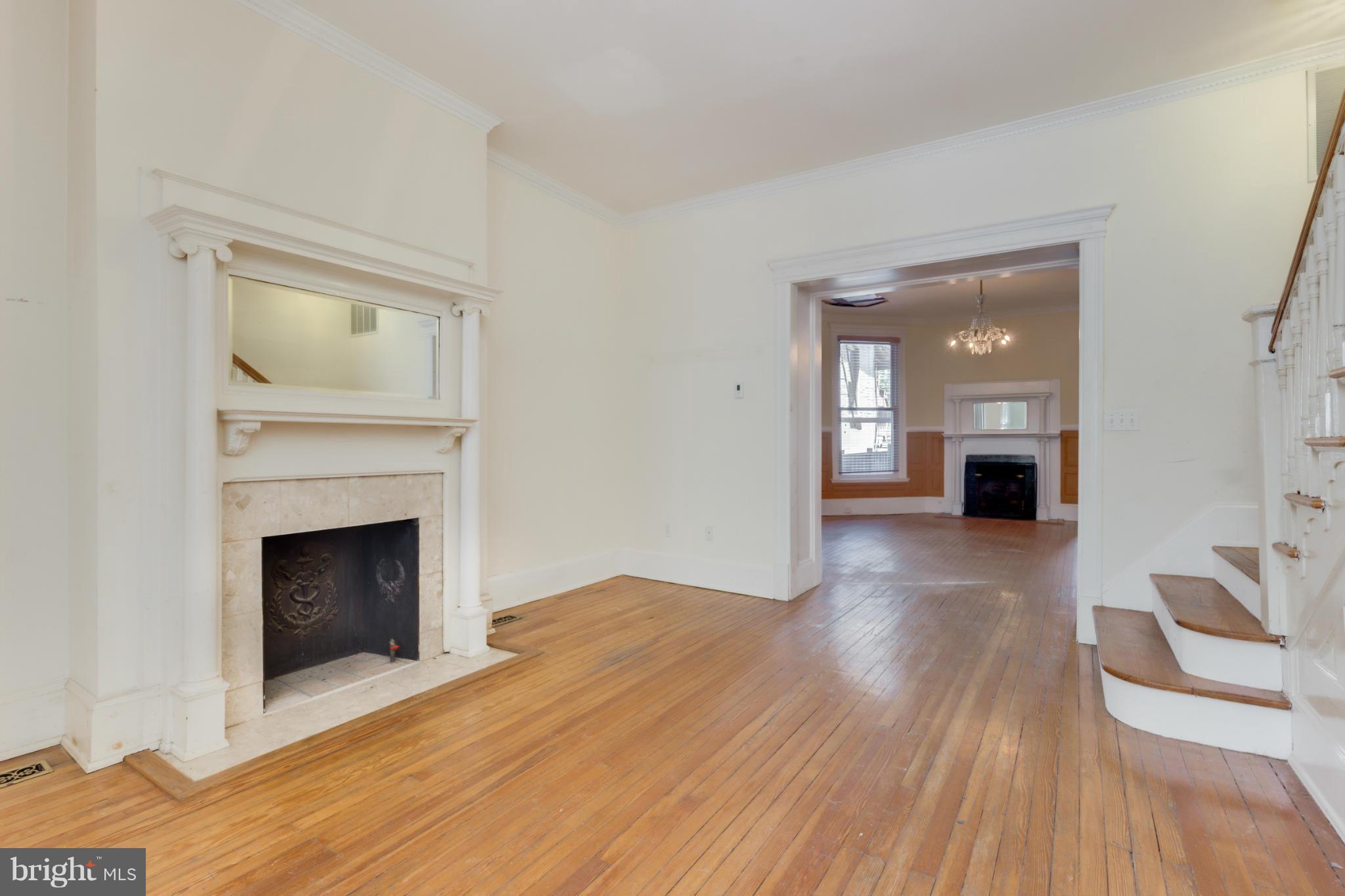 1823 Kalorama Road Northwest Washington, DC 20009 - Photo 2 of 20 a view of a livingroom with wooden floor and a fireplace