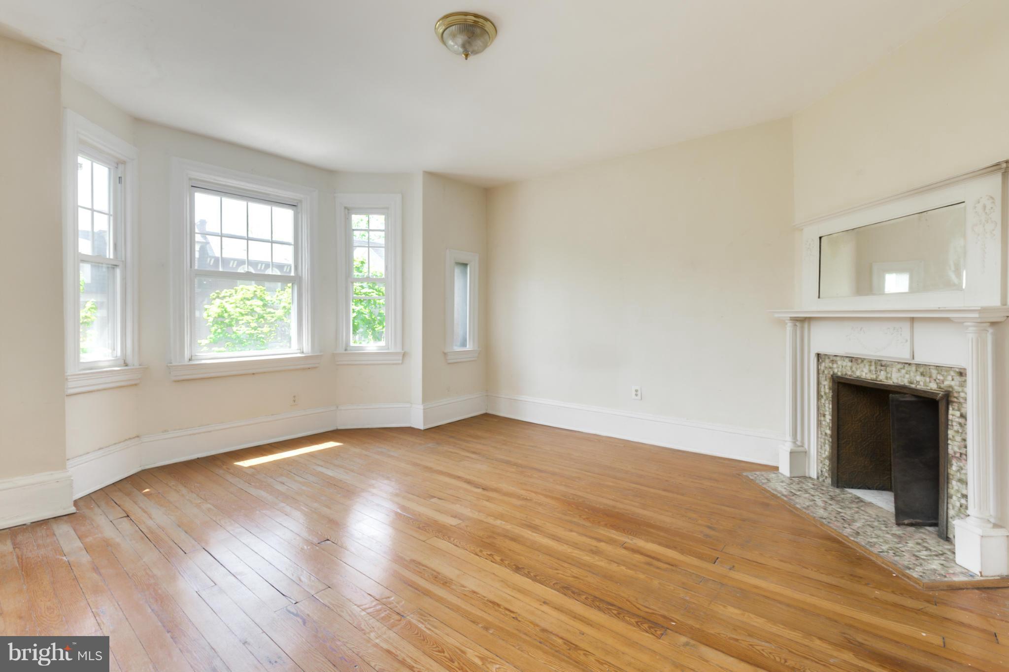 1823 Kalorama Road Northwest Washington, DC 20009 - Photo 11 of 20 a view of an empty room with wooden floor and a window