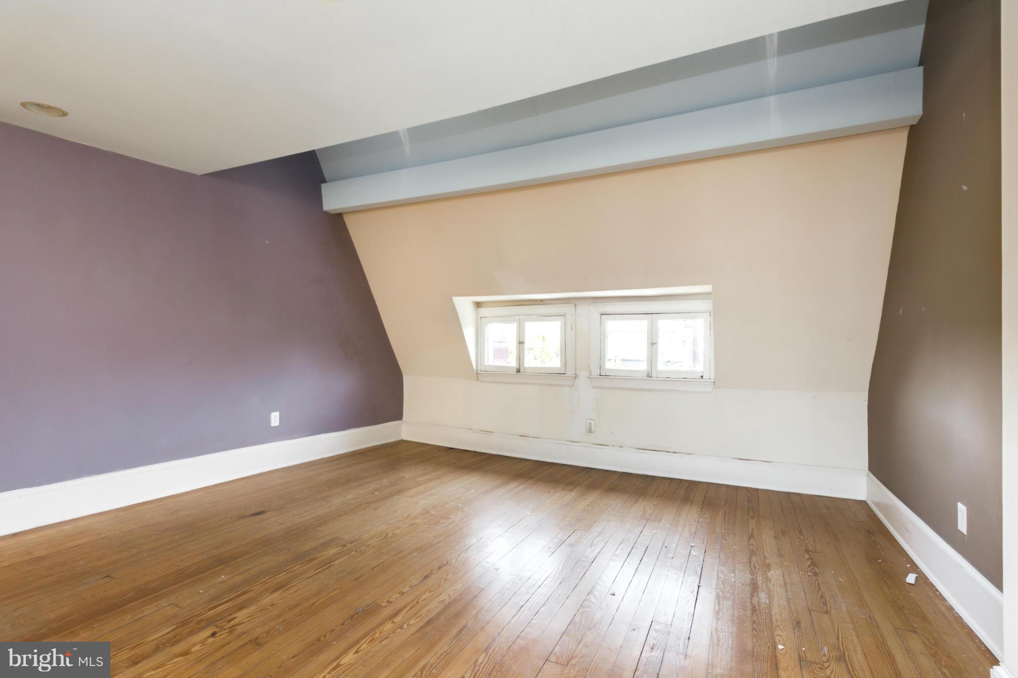 1823 Kalorama Road Northwest Washington, DC 20009 - Photo 14 of 20 an empty room with wooden floor and windows