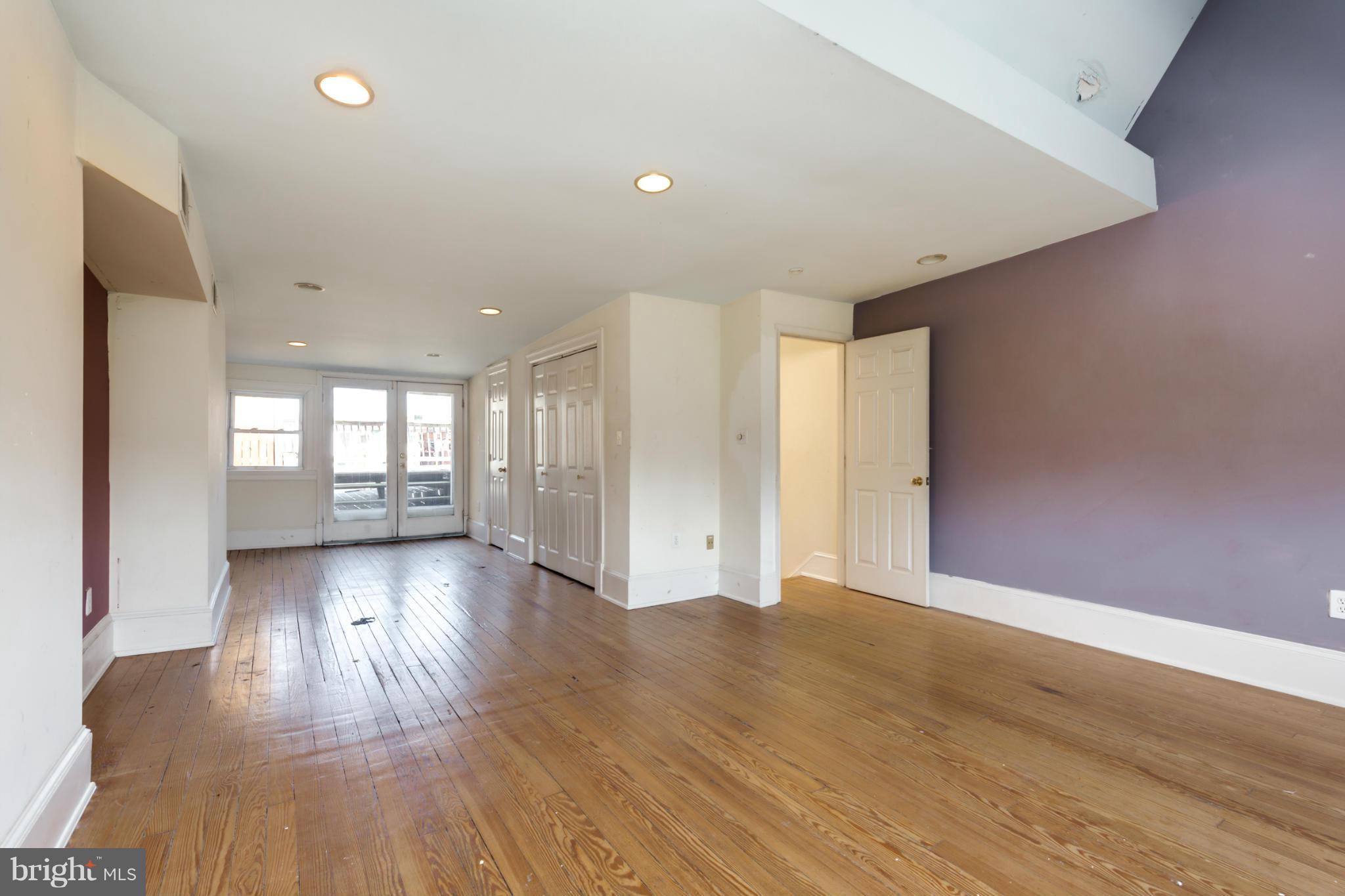 1823 Kalorama Road Northwest Washington, DC 20009 - Photo 15 of 20 a view of an empty room with wooden floor and a window