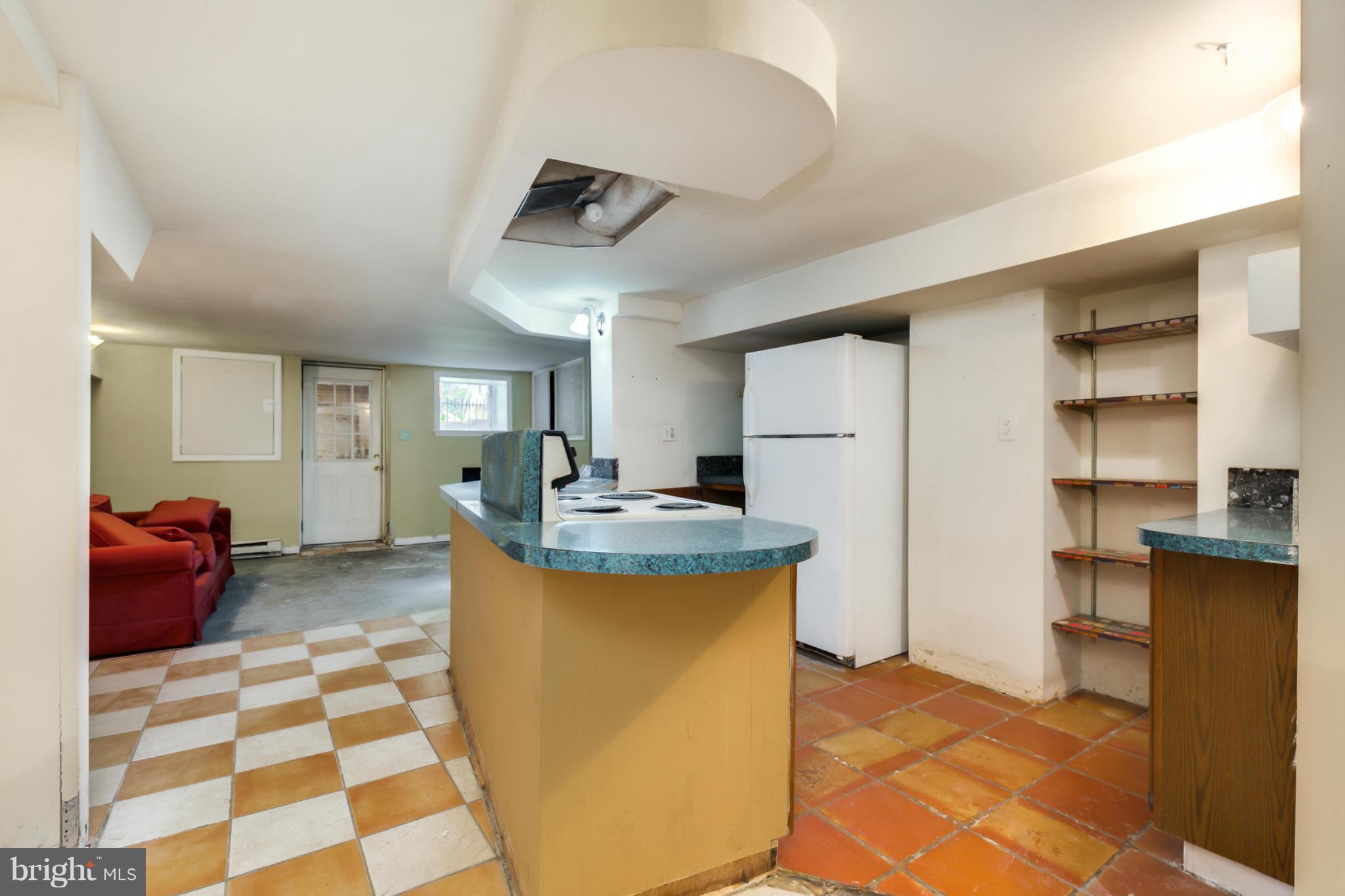 1823 Kalorama Road Northwest Washington, DC 20009 - Photo 17 of 20 a kitchen with stainless steel appliances granite countertop a sink and a refrigerator