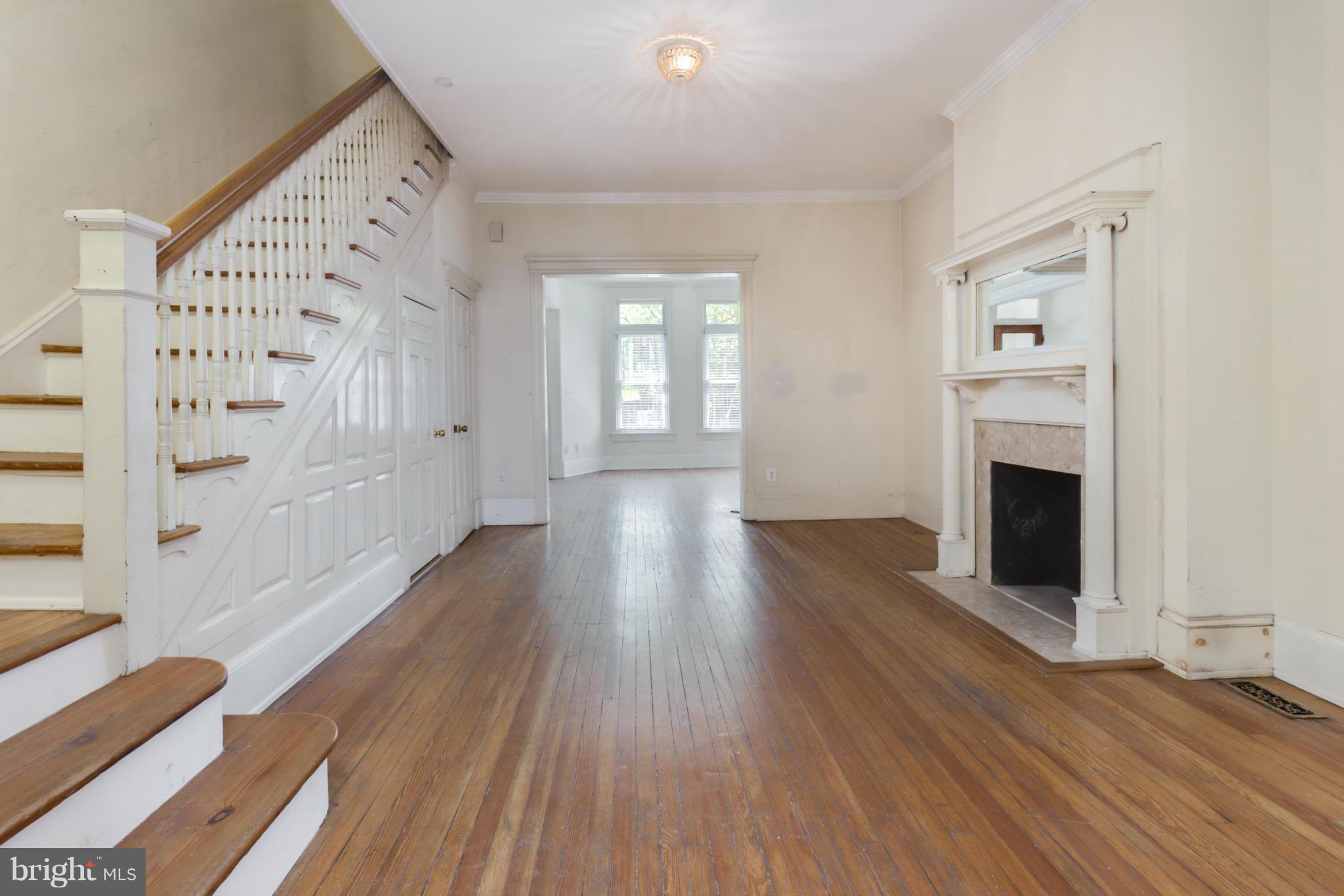 1823 Kalorama Road Northwest Washington, DC 20009 - Photo 4 of 20 a view of an empty room with wooden floor and a window