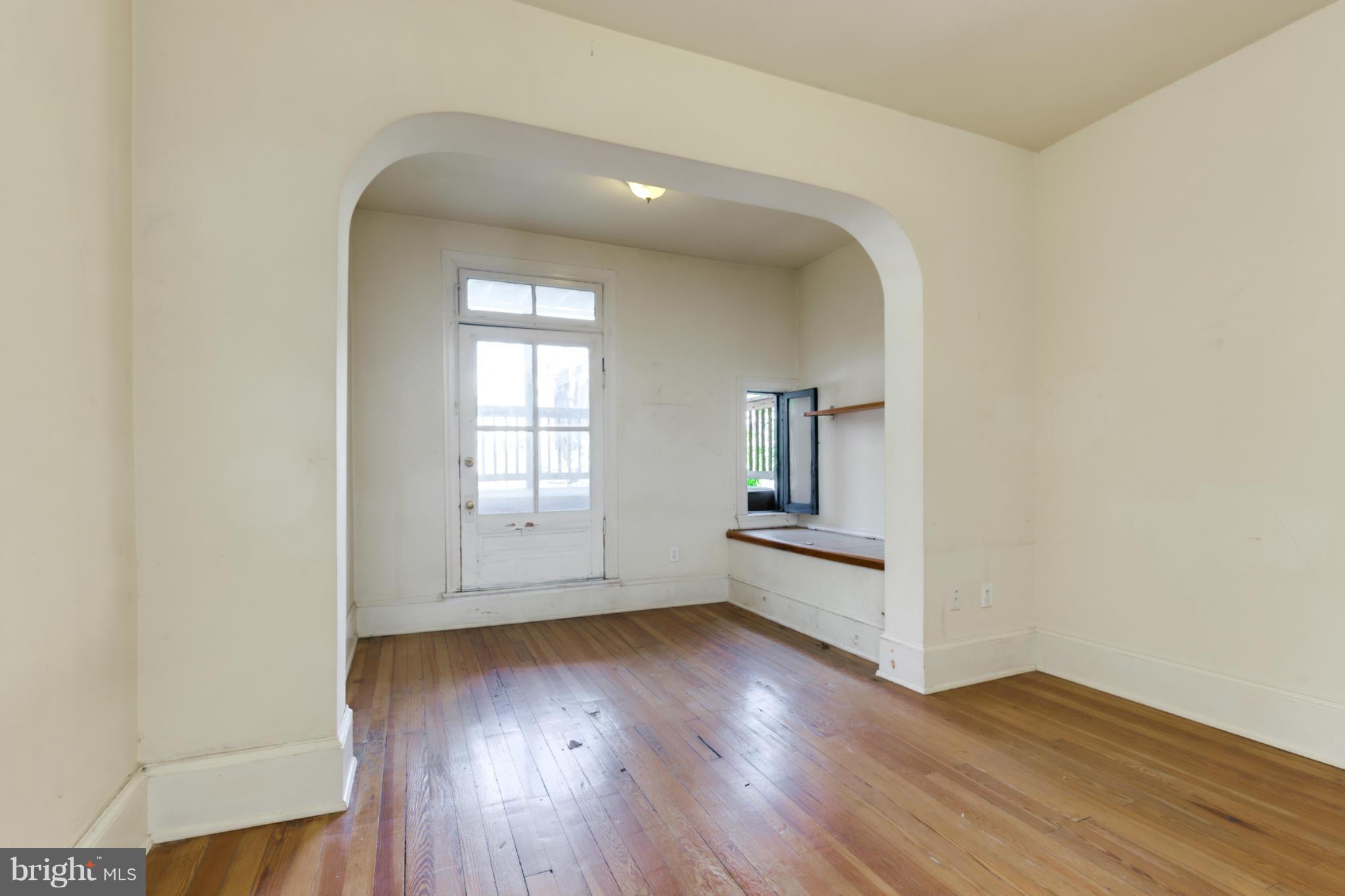 1823 Kalorama Road Northwest Washington, DC 20009 - Photo 10 of 20 an empty room with wooden floor and mirror