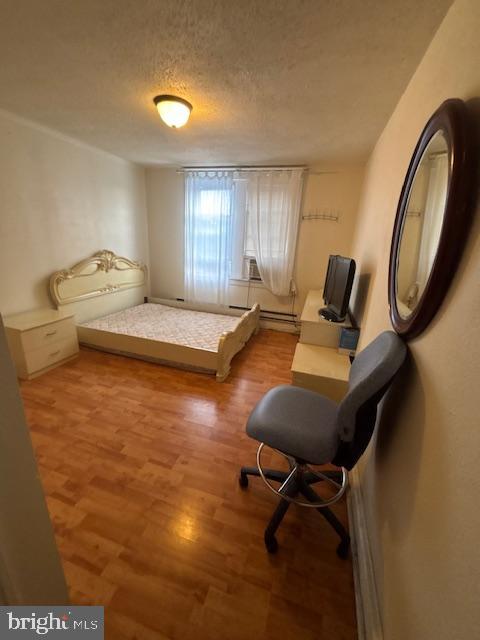 1422 Fanshawe Street Philadelphia, PA 19111 - Photo 12 of 12 a bedroom with a bed and a chandelier