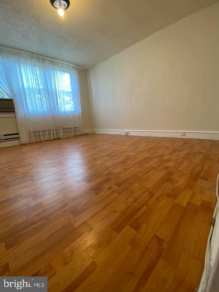 1422 Fanshawe Street Philadelphia, PA 19111 - Photo 10 of 12 an empty room with wooden floor and windows
