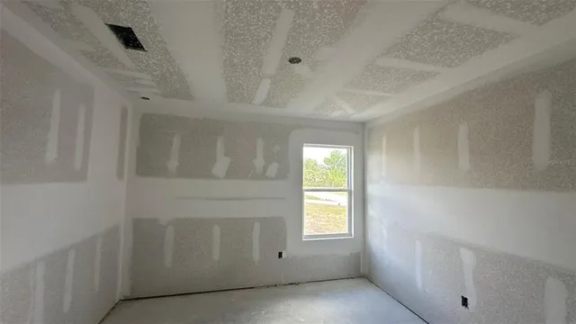 a view of an empty room with a fireplace