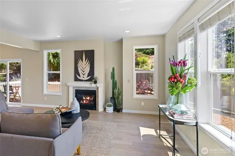 a living room with furniture a fireplace and a window