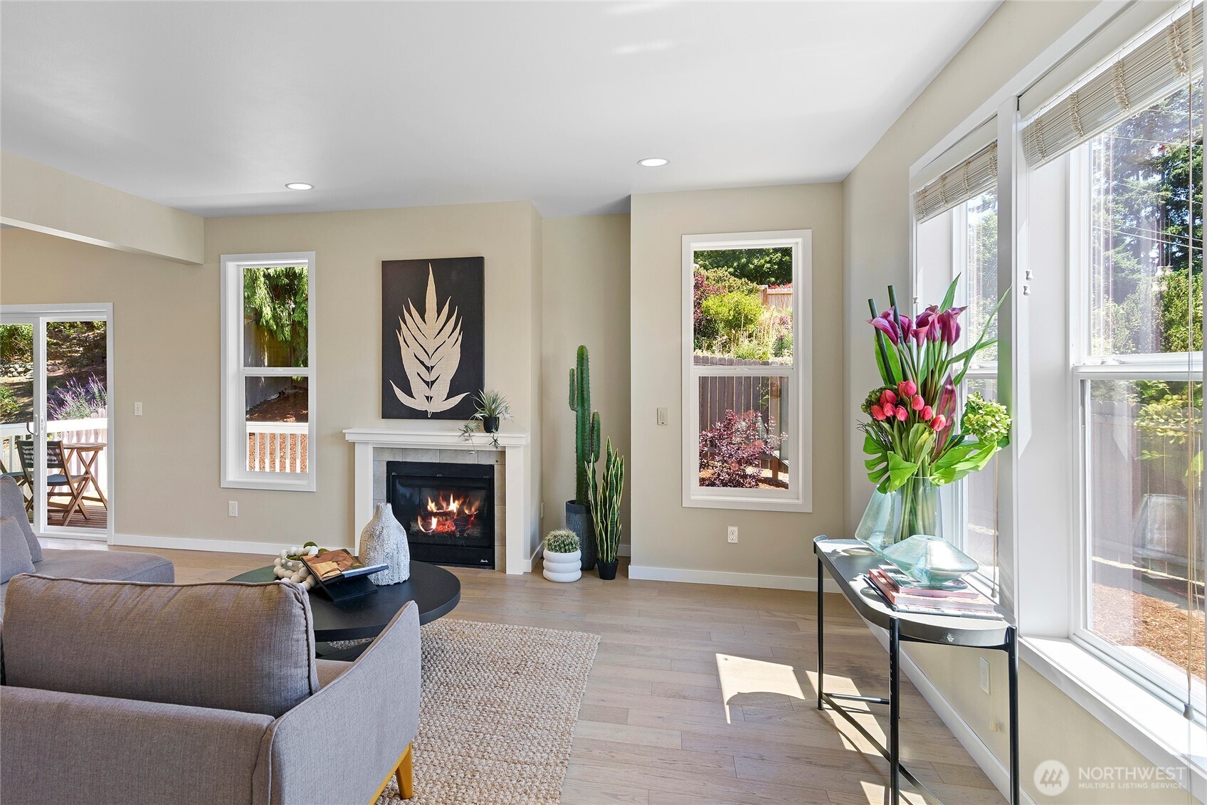 26442 GRAVITY Avenue Northeast Kingston, WA 98346 - Photo 12 of 40 a living room with furniture a fireplace and a window