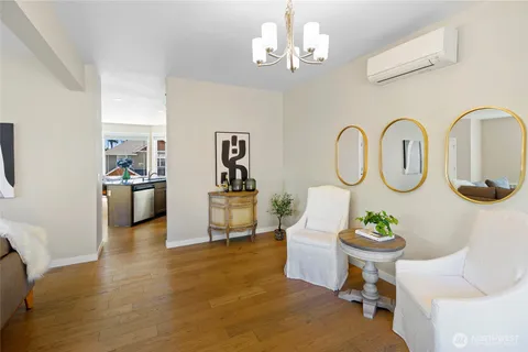 a living room with kitchen island furniture and a chandelier