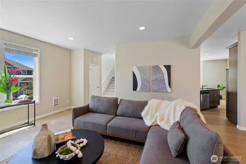 a living room with furniture and painting on the wall