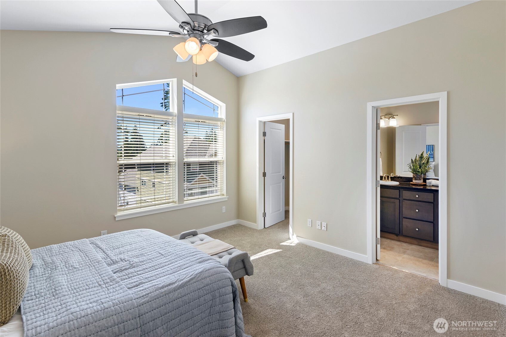 26442 GRAVITY Avenue Northeast Kingston, WA 98346 - Photo 19 of 40 a bedroom with a bed and a chandelier