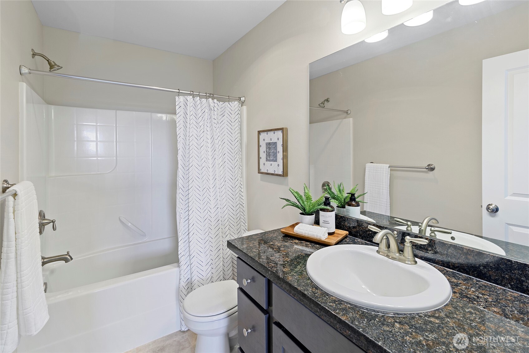 26442 GRAVITY Avenue Northeast Kingston, WA 98346 - Photo 24 of 40 a bathroom with a granite countertop sink a toilet a mirror and shower