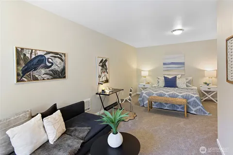 a bedroom with furniture and a potted plant