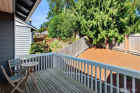 a view of balcony with wooden floor and outdoor seating