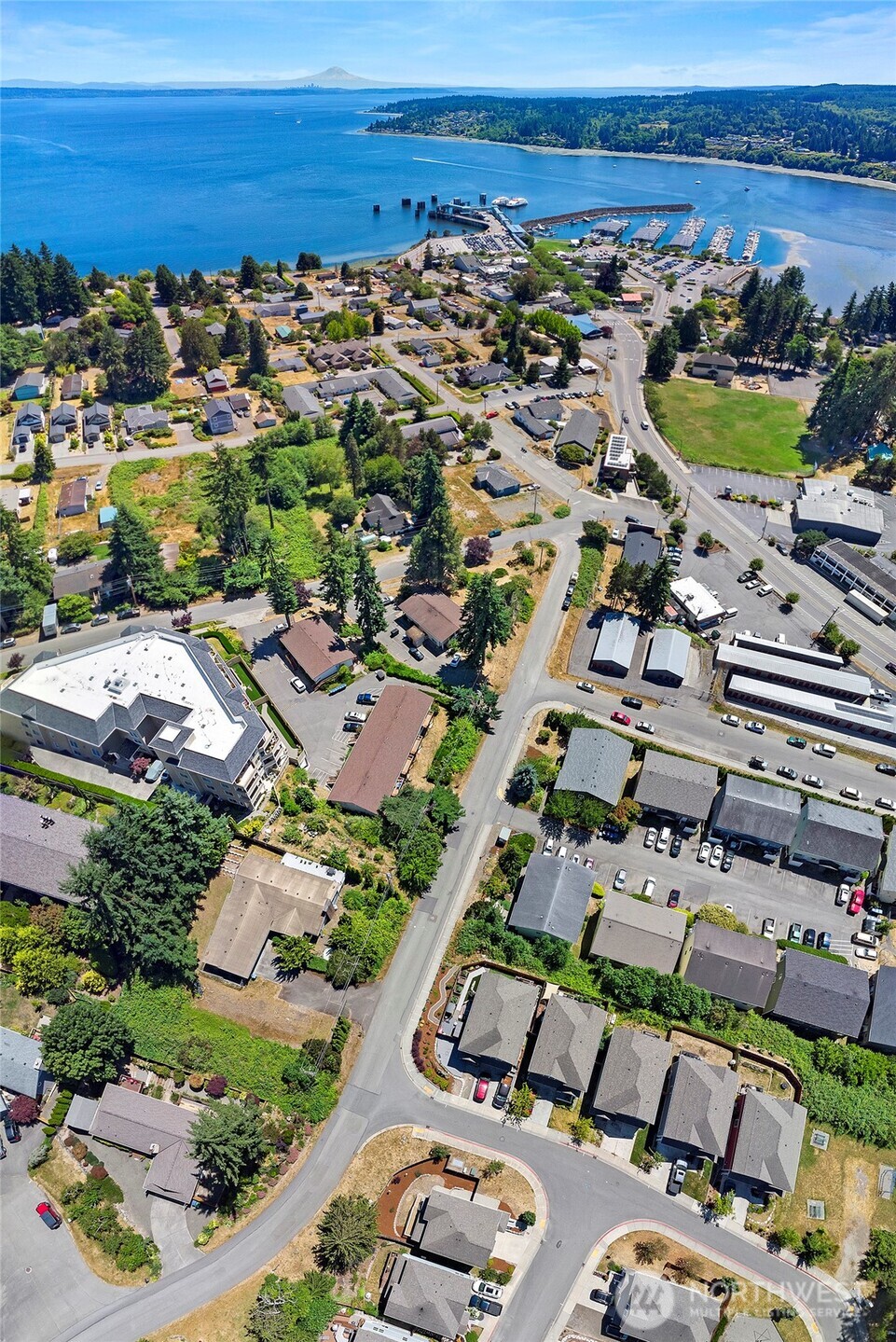 26442 GRAVITY Avenue Northeast Kingston, WA 98346 - Photo 34 of 40 an aerial view of a city with lots of residential buildings and ocean view in back