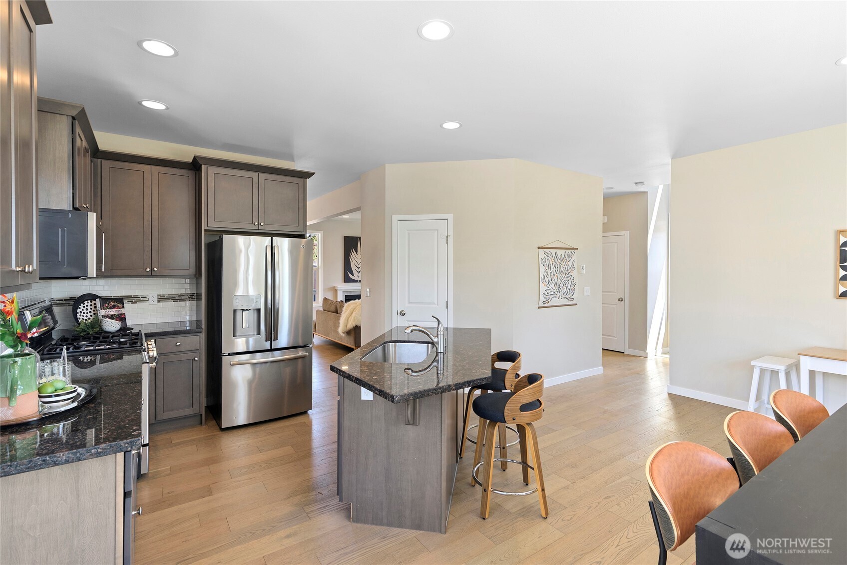 26442 GRAVITY Avenue Northeast Kingston, WA 98346 - Photo 7 of 40 a kitchen with stainless steel appliances granite countertop a refrigerator and a stove top oven